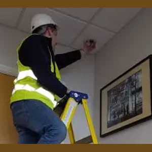 Man installing home security camera