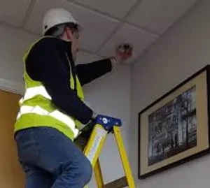Man installing home security camera